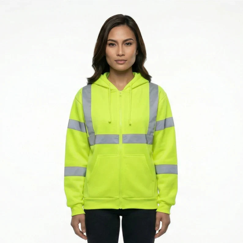 Worker wearing ANSI Class 3 safety green hi-vis zip-up hoodie with reflective tape and front pockets